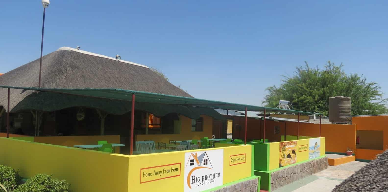 Thatched bar with the Big Brother menu board
