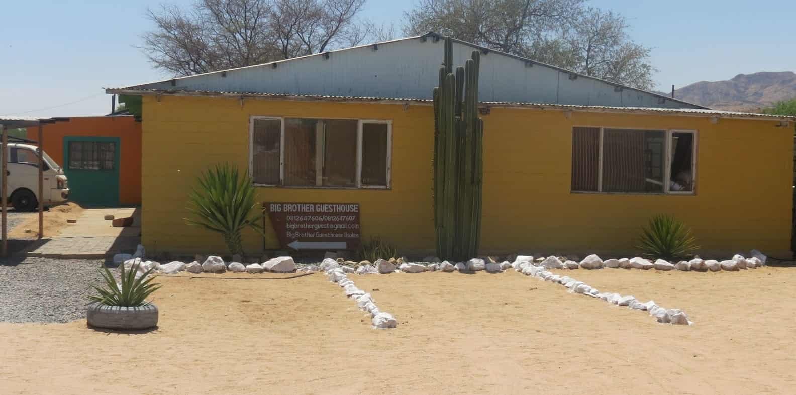Main guesthouse building painted yellow and green