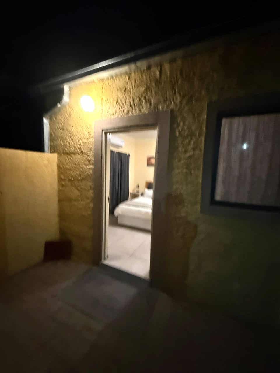 Doorway glowing warm after dark