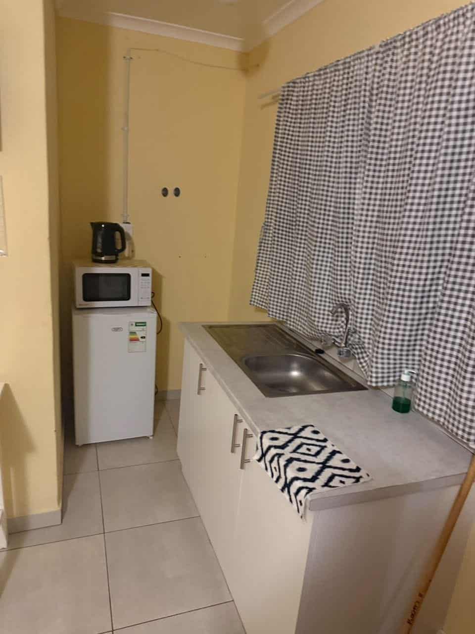 Kitchenette counter with kettle and patterned cloth