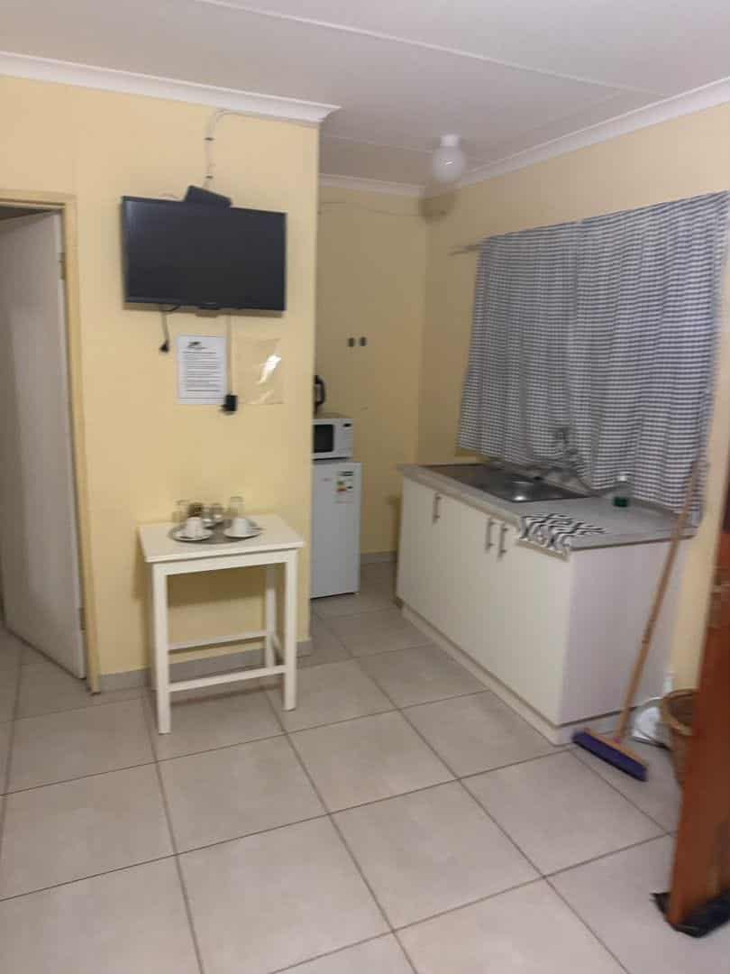 Kitchenette with microwave, fridge and sink