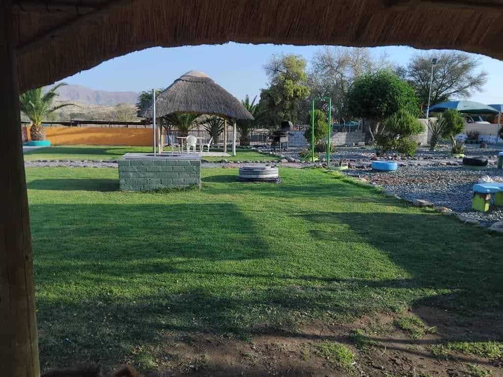 Thatched umbrella and braai corner on the lawn
