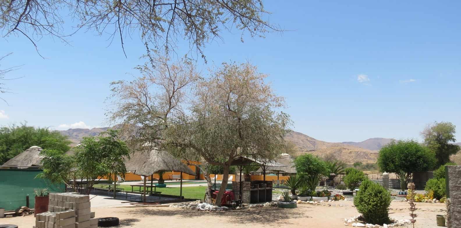Lawn with thatched lapas and trees