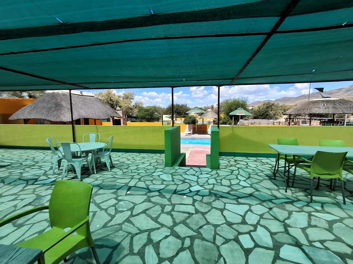 Shaded patio with tables on the painted stone floor