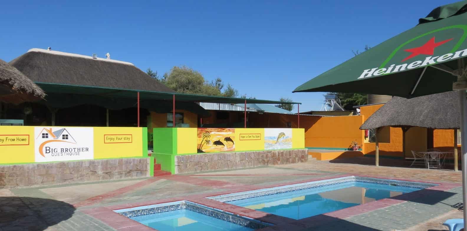 Pool deck with umbrella and loungers