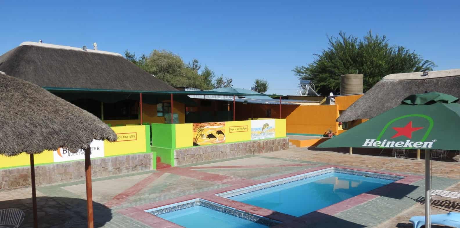 Pool with green umbrellas and loungers
