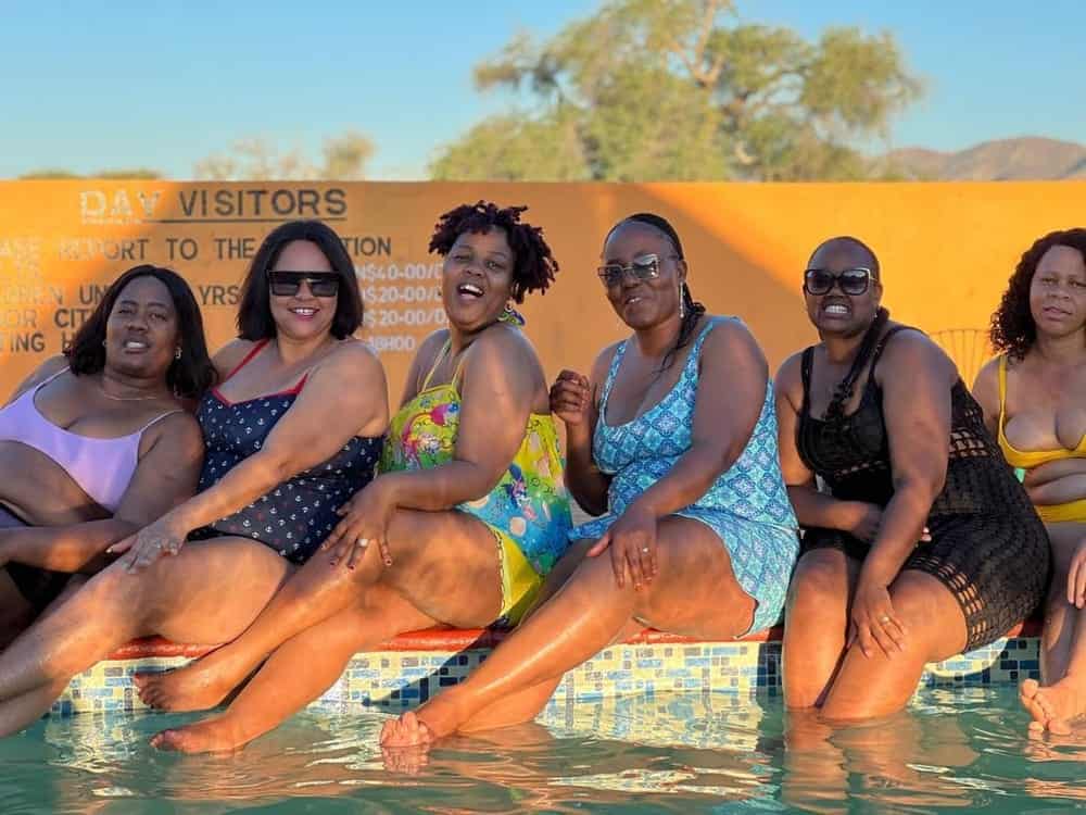 Group at the pool under the welcome sign