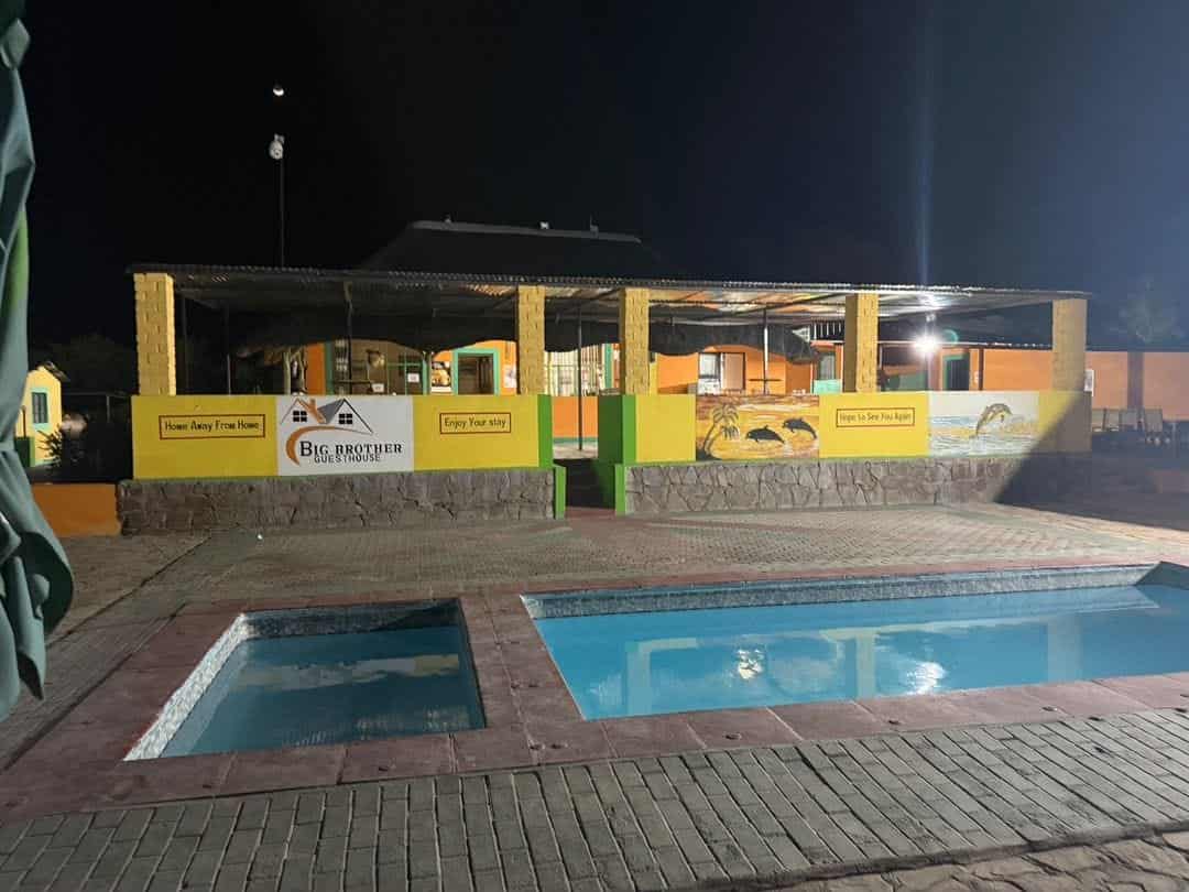 Pool and lit umbrellas after dark