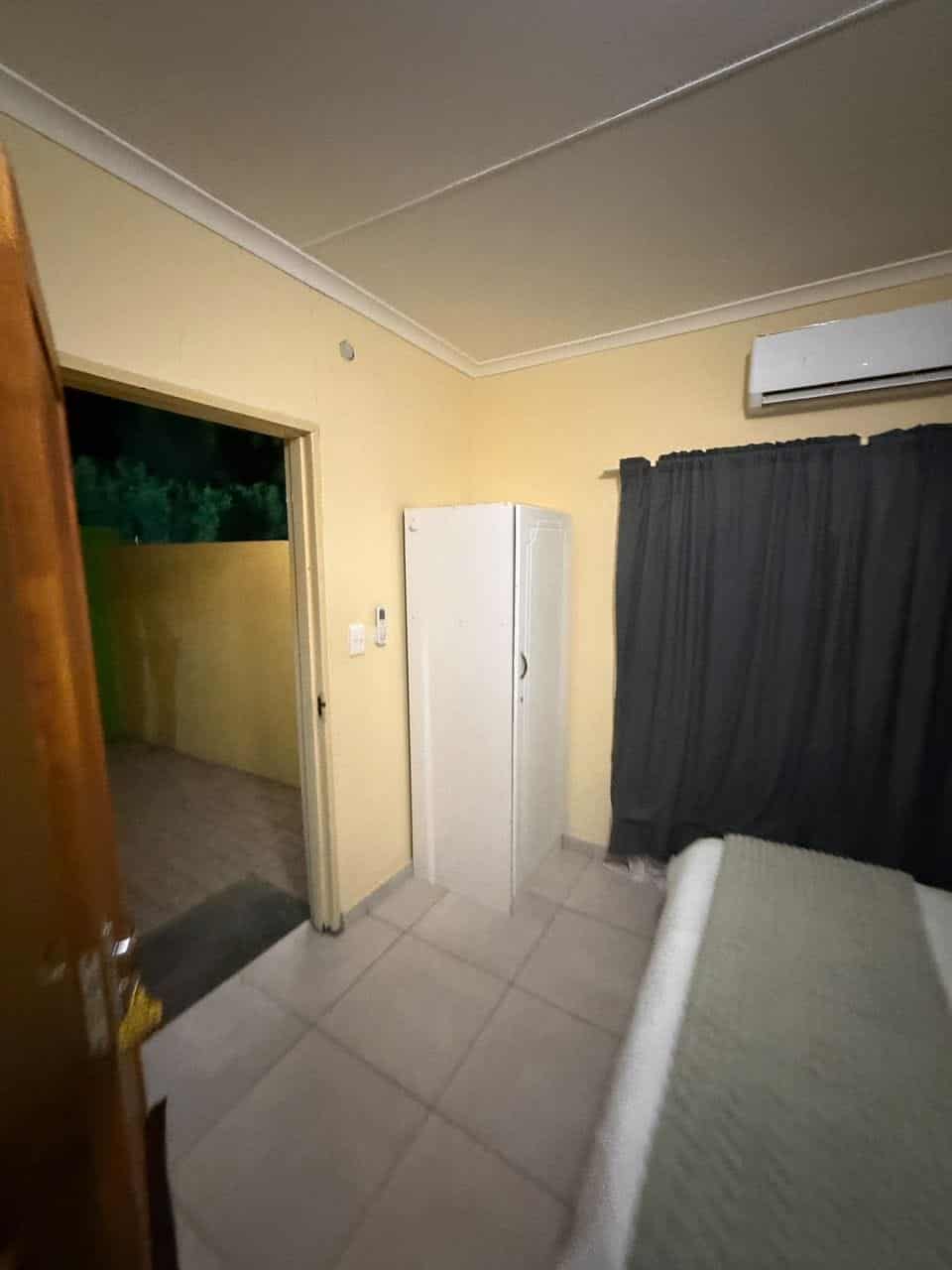 Room with air-conditioner and dark curtains