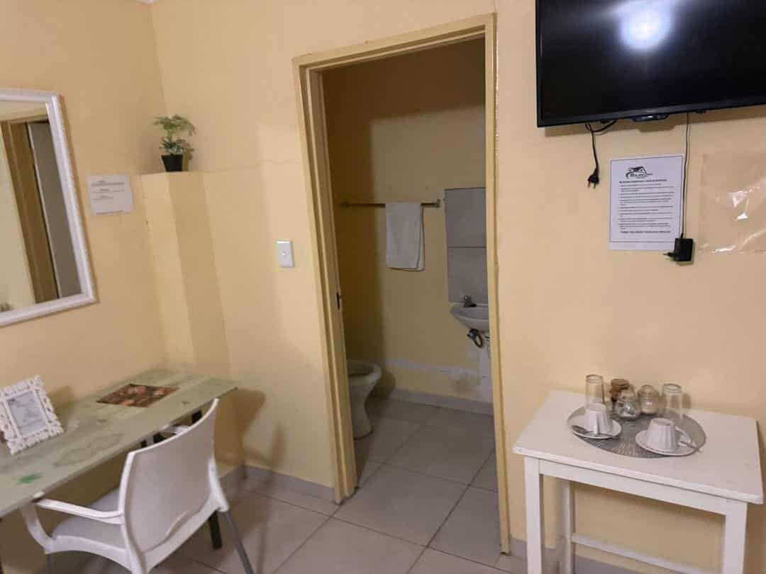 Room with a work desk, mirror and wall television