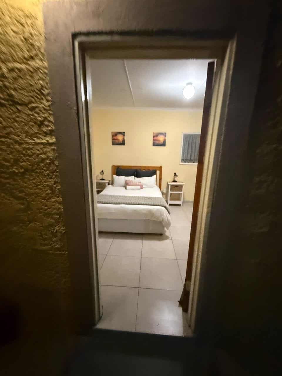 Open doorway onto a made-up bed