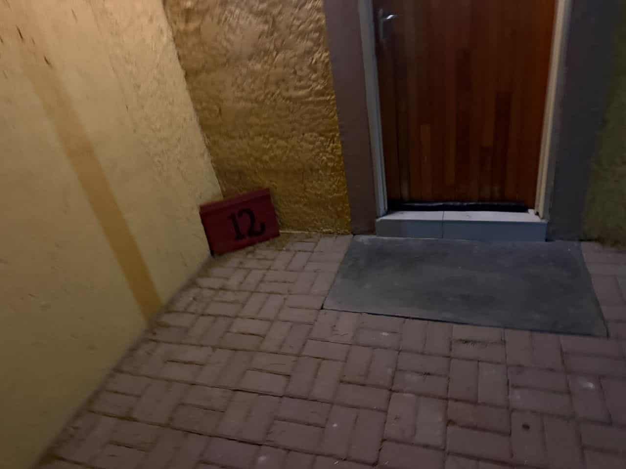 Room entrance with brick paving and shade cloth