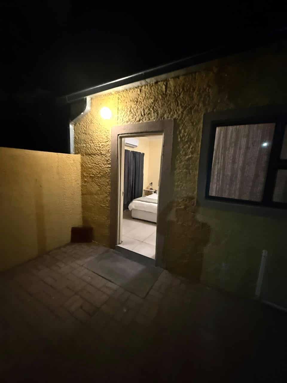 Warm room light spilling into the night