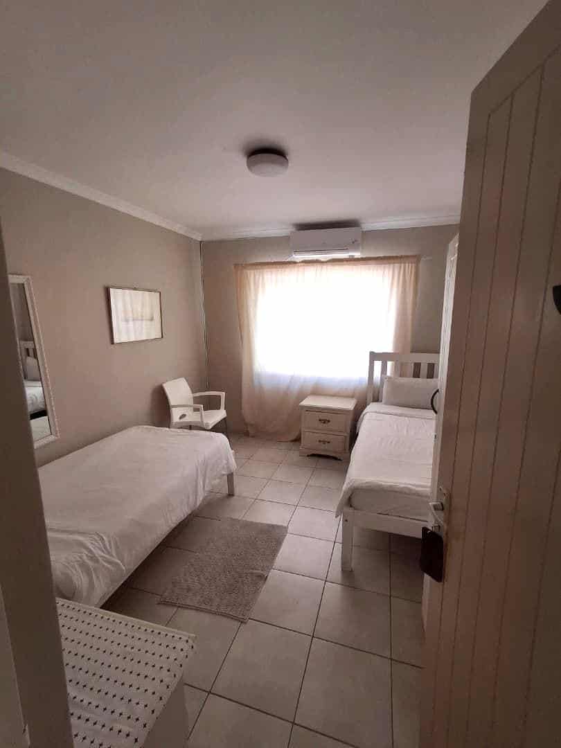 Simple room with a bed beside a bright window