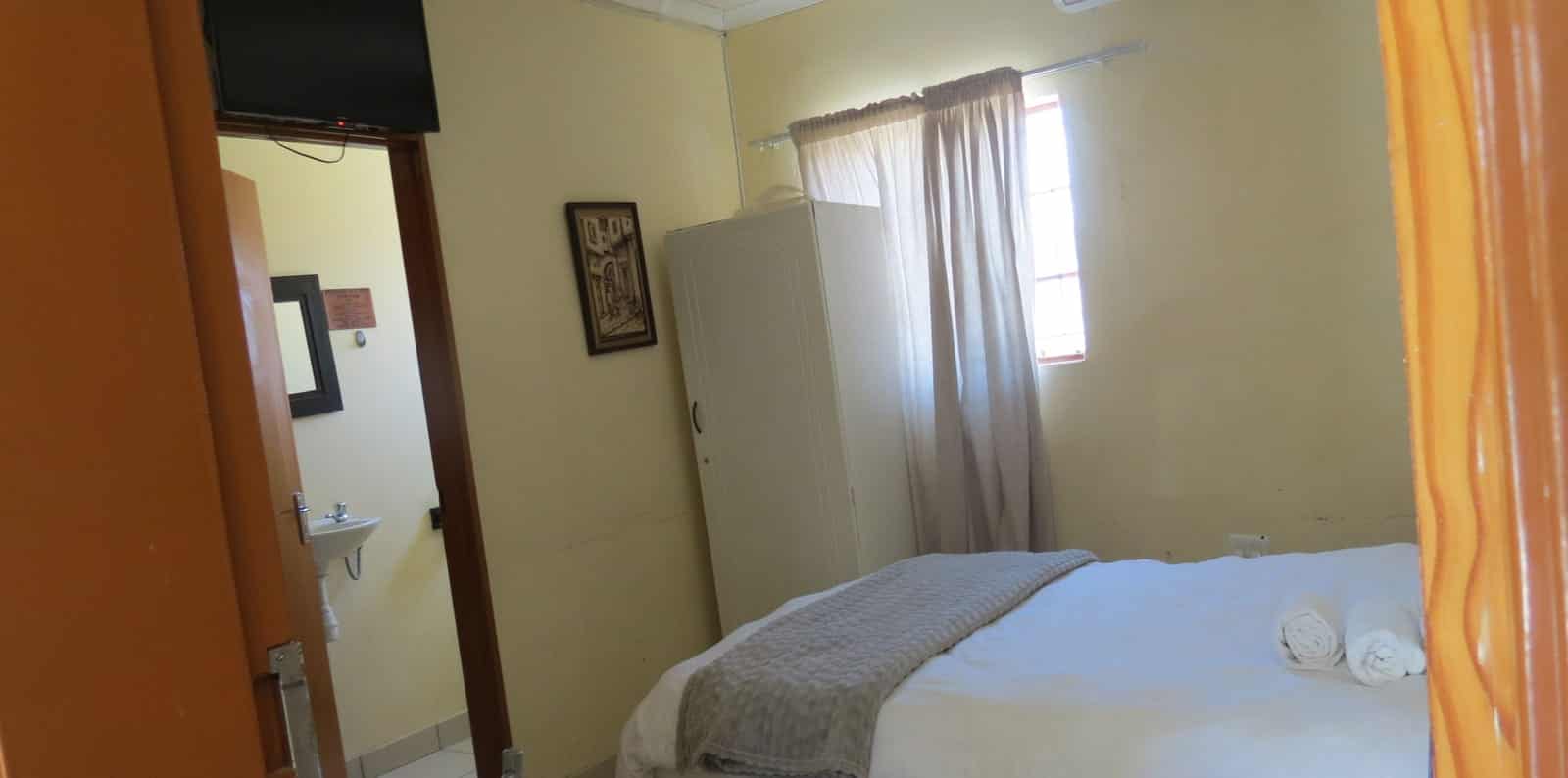 Room with wardrobe, mirror and tiled floor