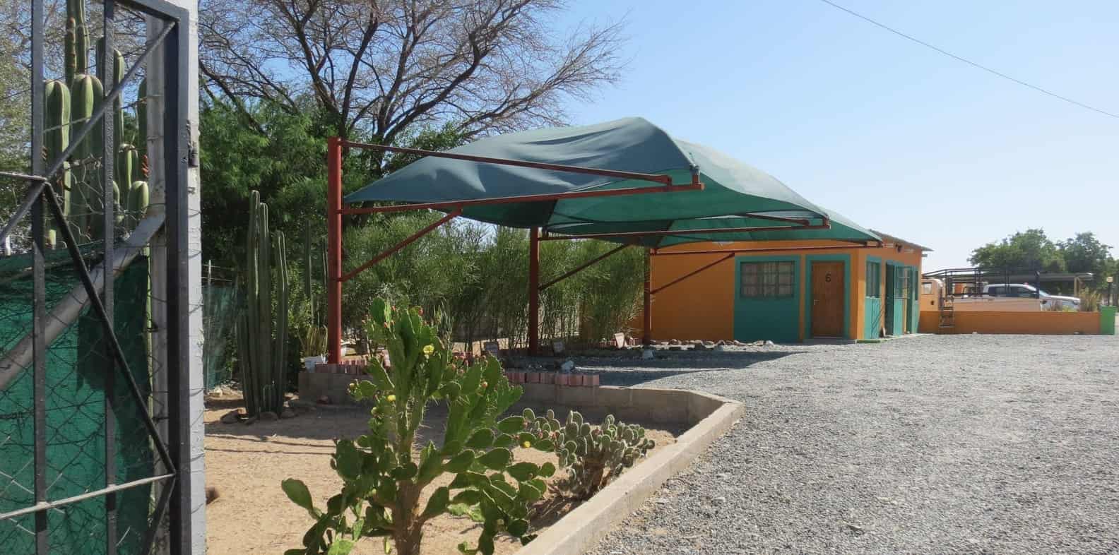 Green shade sail over the entrance parking