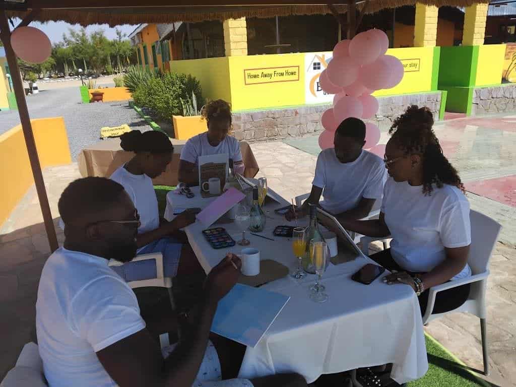 Friends around a dressed table with balloons