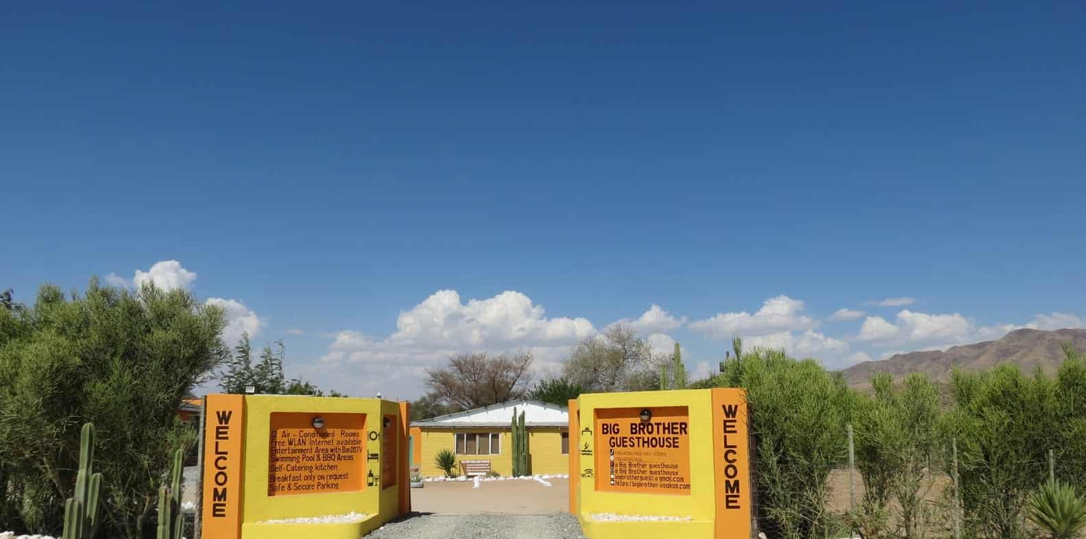 Welcome boards flanking the entrance road
