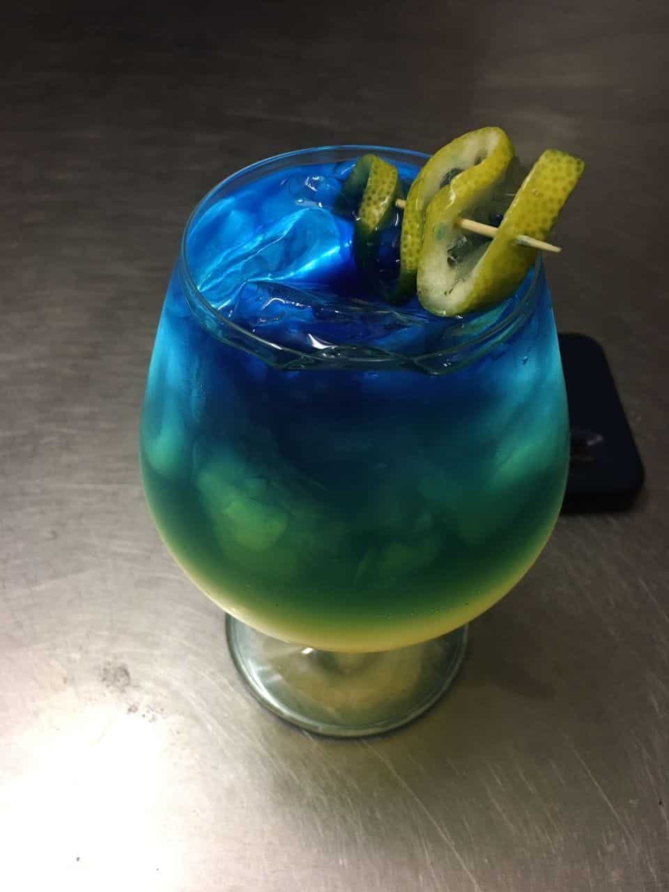 Blue cocktail in a balloon glass