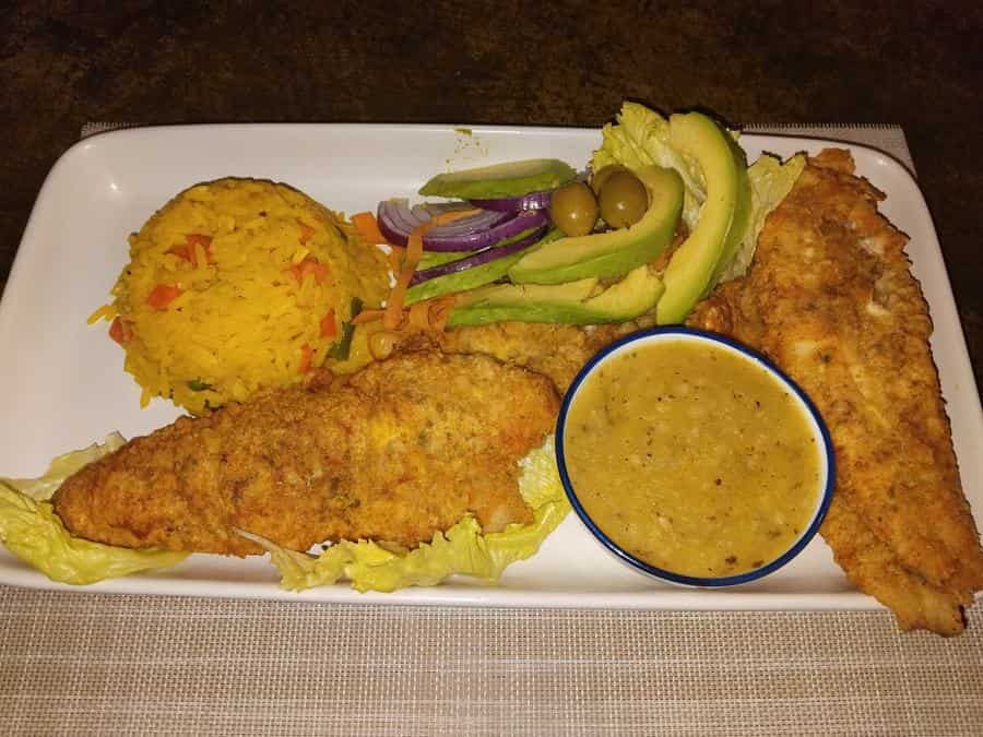 Crumbed fish fillet with rice and sauce