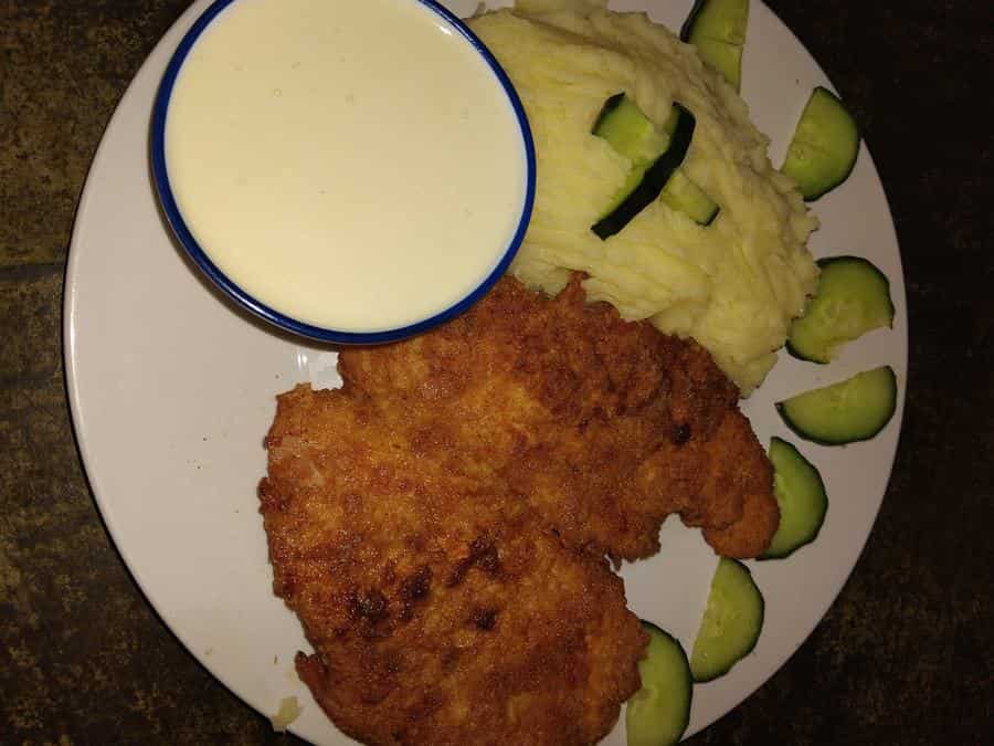 Crumbed schnitzel with mash and creamy sauce