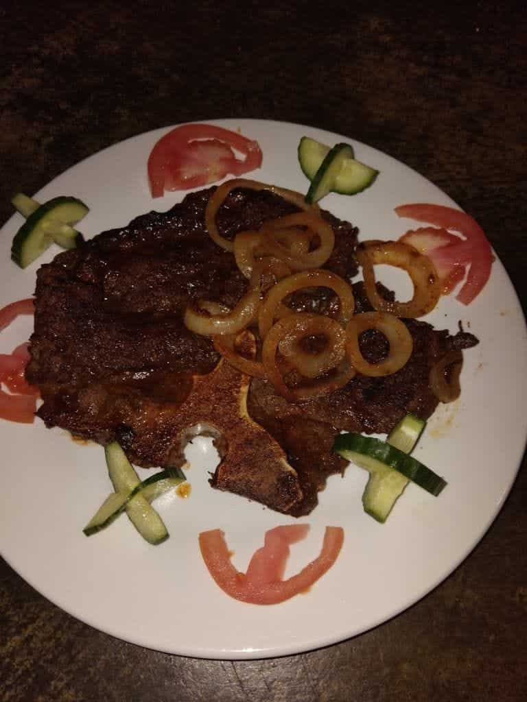 Steak topped with onion rings
