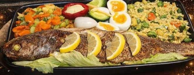 Whole fish platter with eggs, rice and salads