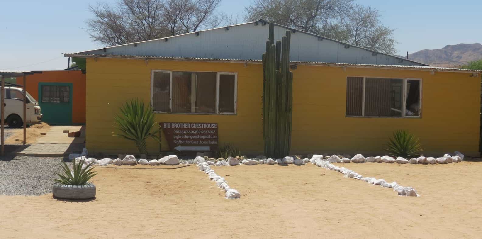 The Big Brother Guesthouse main building painted yellow and green