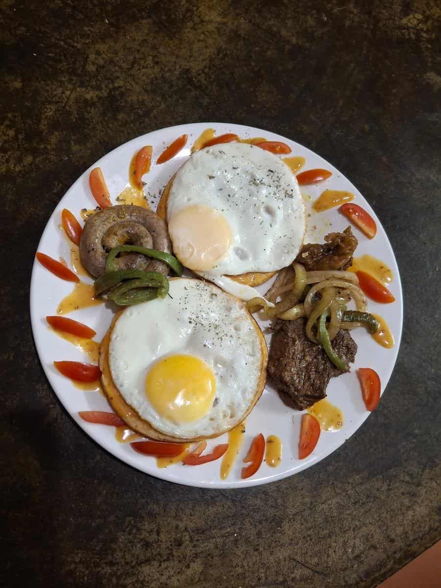 English breakfast with eggs, steak and onions