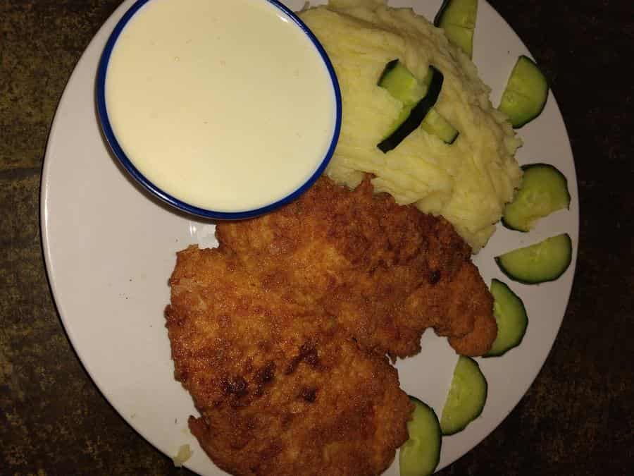 Crumbed schnitzel with mash and creamy sauce